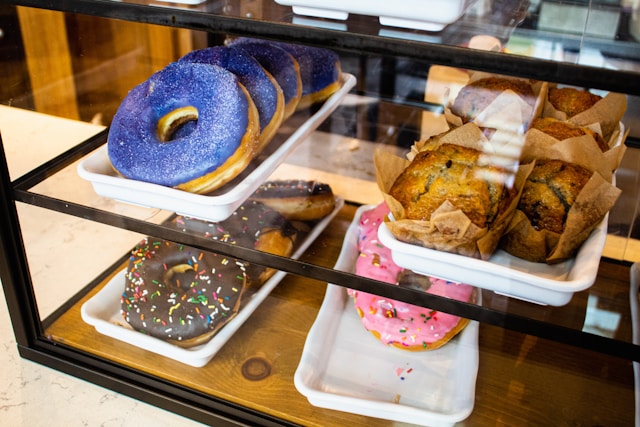 Donuts on display in a glass case.