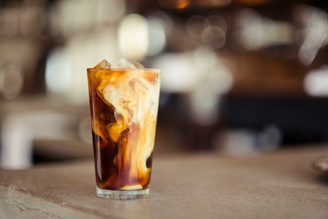 An iced coffee sitting on a table.