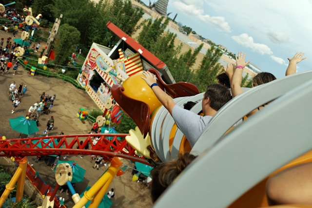 People enjoying a thrilling roller coaster ride in the exciting setting of Toy Story Land.