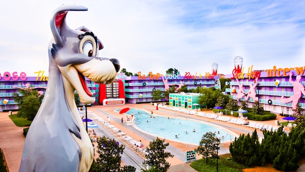 a large animal statue next to a pool