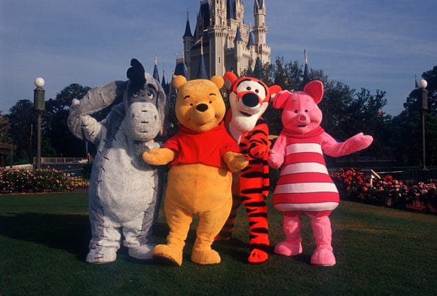 Vintage photo of Eeyore, Pooh Bear, Tigger, and Piglet in front of Cinderella Castle at Magic Kingdom.